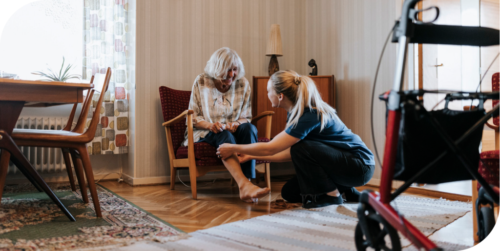 A clinician with a patient, wound management and pain scales.